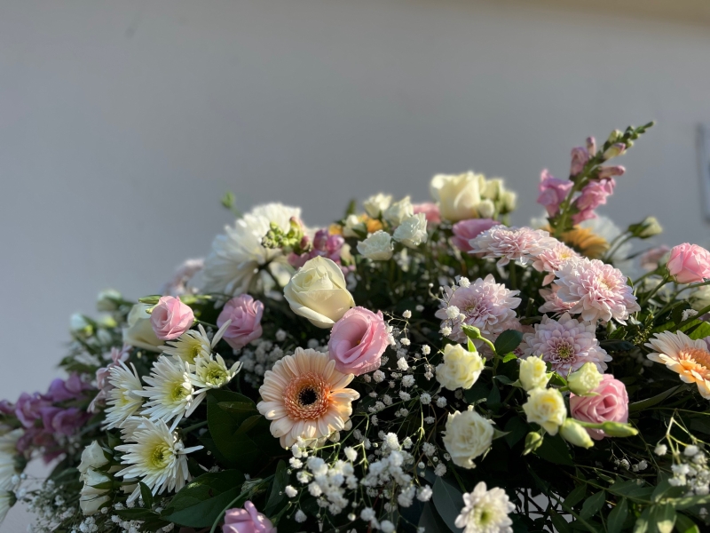 Soft pastels casket spray
